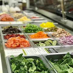 A variety of fresh vegetables, toppings and other pizza ingredients